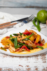 Chicken salad. Traditional Asian flavours. Salad made with boiled chicken and vegetables. Chicken salad appetizer on a white wood background. Close up