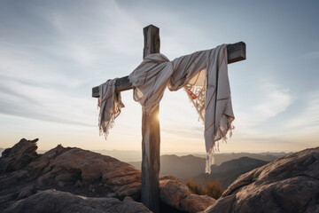 Wooden cross with white scarf at sunrise on rocks. Easter and crucifixion theme - 747074867