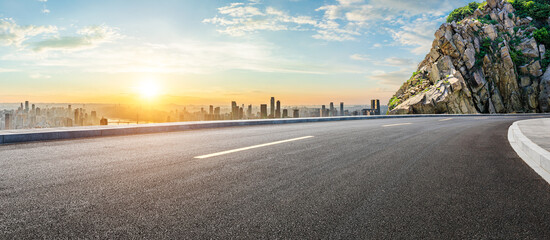 Asphalt highway road and mountains with city skyline at sunset in Chongqing - obrazy, fototapety, plakaty