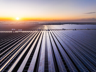 Aerial view of solar panel landscape at sunset. green energy concept. Photovoltaic power station on...