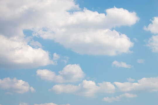 Bright sky background with white clouds.