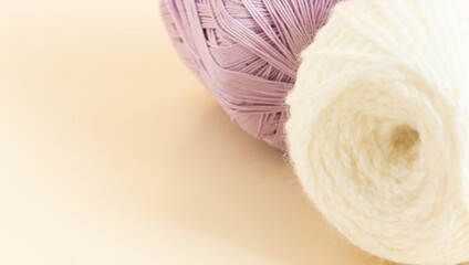 White balls of thread on a light background, for a banner