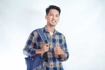 Portrait of smiling happy young Asian boy student wearing casual clothes and backpack showing thumbs up isolated on white background. high school university college concept