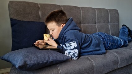 During leisure hours child is deeply engaged in tablet games showcasing childs fascination with...