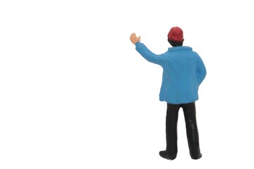 miniature figurine of man with hat waving or inviting someone to stop isolated on white background