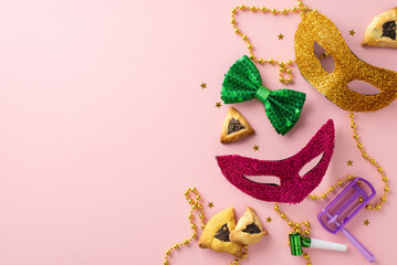 Join our Purim festivity! View from top of triangle cookies, masquerade accessories, bow tie, beads, confetti, party blower, and graggers on a light pink surface with area for text or promotions