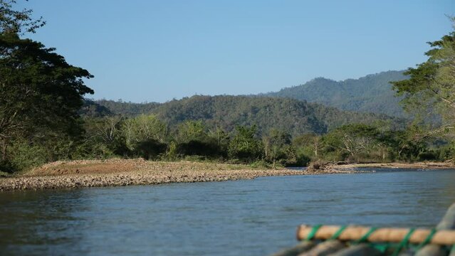 Closeup of bamboo rafting in the river with mountain and nature view