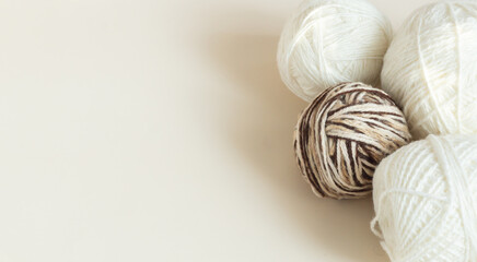 White balls of thread on a light background, for a banner