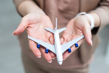 Female woman hands holding small toy model plane. Travel by plane vacation weekend adventure trip...