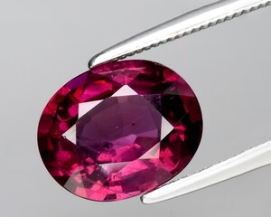 natural red pink garnet rhodolite gem on the background