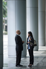 Happy Indian Business colleagues talking to each other.