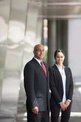 Indian business man and woman in a modern urban setting.