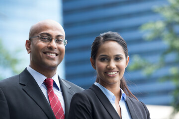 Indian business man and woman in a modern urban setting.