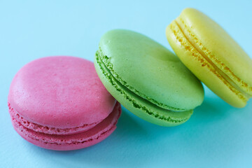 Colorful macaroons on blue background. Sweet macaroon.
