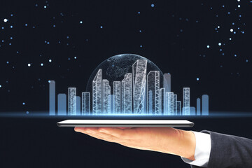 Holographic projection of a cityscape on a tablet held by a businessman against a starry night...