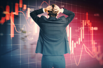 Back view of stressed out businessman looking at falling red forex candlestick chart on blurry background. Global economic recession, stock market crash, inflation concept.