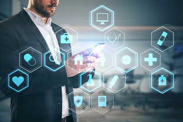 Side view of headless european businessman using smartphone with creative glowing blue medical...