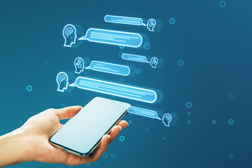 Close up of female hand holding smartphone with creative chat GPT hologram with speech bubbles on blurry blue background. AI concept.