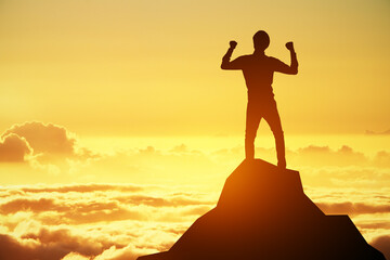 A dynamic silhouette of a person with fists up in the air on a mountain top, with sunrise depicting...