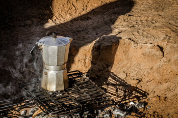 Espresso Pot warming up on a camp fire 