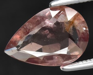 natural peach sapphire gem on the background