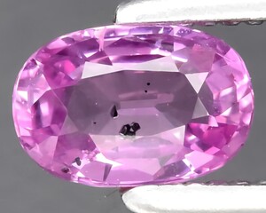 natural pink sapphire gem on the background