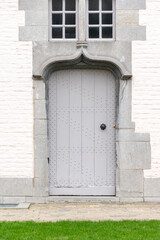 old wooden door with wall,Gray wooden door against the background of a gray brick wall, rustic doors