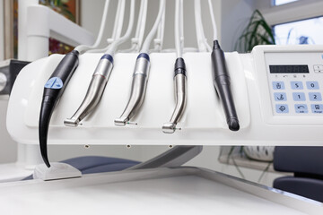 Different dental instruments and tools in a dentists office, Orthodontist grabbing dental metallic tools, Close up detail of dentist work tools.