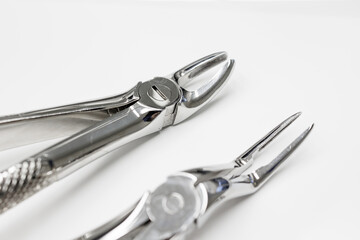 Forceps close up ,set of tools isolated on white, set of metal dental instruments, Dental extraction forceps.