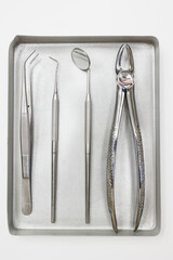 Dental instruments, forceps close up ,set of tools isolated on white, set of metal dental instruments. Dental extraction forceps