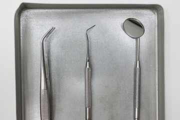 Orthodontist grabbing dental metallic tools, Set of metal medical equipment tools for teeth dental care.
