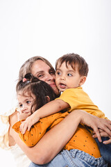 Portrait of a mother hugging her two children with Copy Space on white background