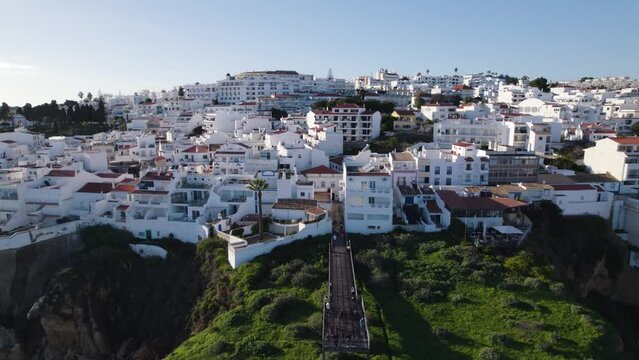 Panoramic Aerial Establishing Overview of White Walled Luxury Home Buildings on Cliffs of Albufeira Portugal Looking over Ocean