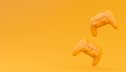 Video game joysticks or gamepads in plain monochrome yellow color background © Vasyl Onyskiv