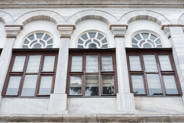 Fototapeta na wymiar Tree windows on Vintage architecture classical facade of a historical building.