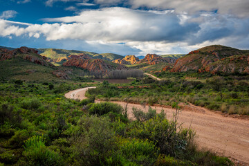 Red Stone Hills, Calitzdorp Farm in the Karoo with old rural houses, valleys pastures aloes and...