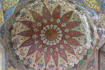 View of the colorful floral and geometric mural painting inside dome of historic Wazir Khan mosque, Lahore, Punjab, Pakistan