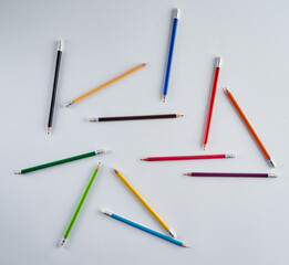 Many rainbow colored pencils on white