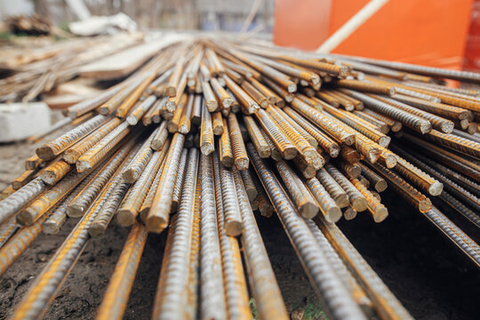 Reinforcement rods at construction site. Steel rebar close up. Rusty steel reinforcement bars for concrete. Process of house building