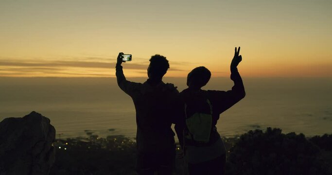 Sunset, mountain or couple in selfie for hiking outdoors in nature to post on social media or mobile app. Silhouette, peace sign or back of people in a picture or photo for trekking together at night