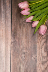 pink tulips on wooden background