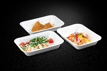 A variety of healthy and delicious meal options in eco-friendly takeaway containers.