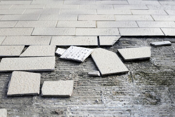 Cracked brown tiles on cement floor