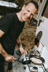 man is cooking outdoors