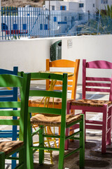 View of colourful chairs and tables at a picturesque bar in Ios Greece
