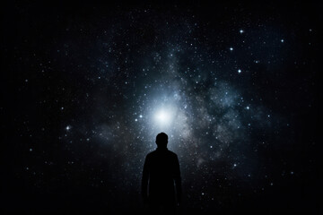 Starry Way: A Man's Silhouette Standing on a Mountain Peak, Embracing the Beauty of the Universe in a Cosmic Landscape.