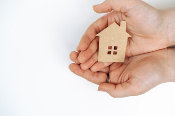 hands holding paper house, family home, homeless housing, mortgage crisis and home protecting insurance concept, foster home care, family day care, social distancing.