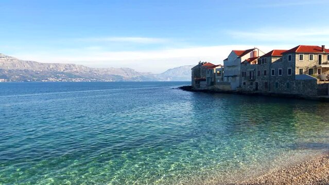Beautiful view of seaside town and mountain range. Costal town of Postira. Brac Island, Croatia. Europe.