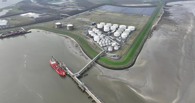Liquids Storage Terminal in Terneuzen, The Netherlands. Transportation of energy products, fossil , bio fuels intermodal logistics and storage. Aerial birds eye view.