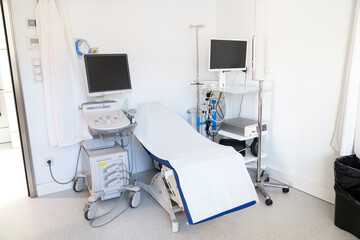 A white and sterile medical room with advanced ultrasound technology.